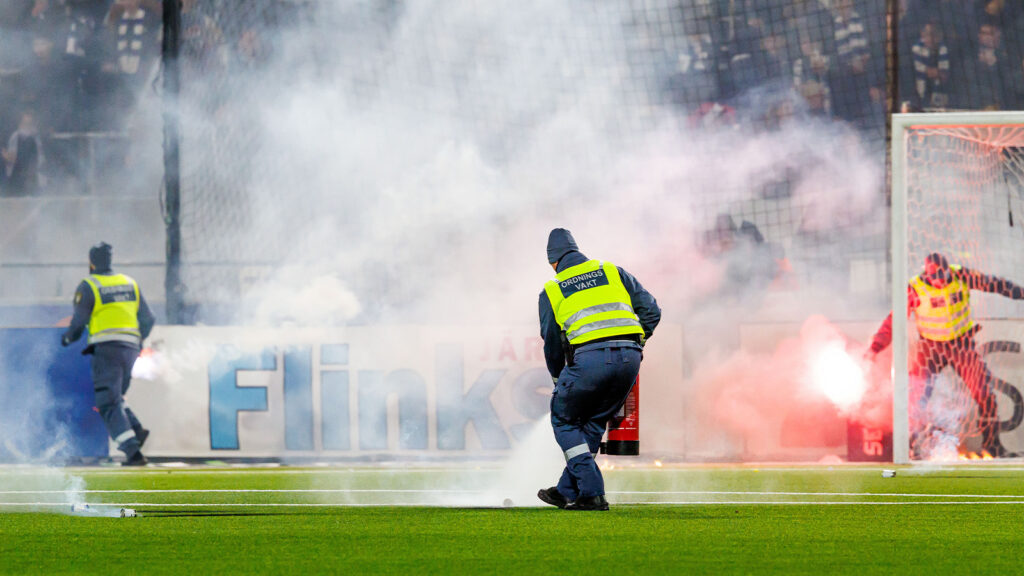 251129 Ordningsvakter släcker eld på gräsmattan under match två i kvalet till Allsvenskan mellan IFK Norrköping och Örgryte den 29 november 2025 i Norrköping.
